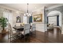 Elegant dining room featuring stylish wallpaper, modern chandelier, and hardwood floors at 1003 North Ne Ave, Atlanta, GA 30306
