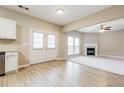 Bright living room with fireplace, neutral paint, and open access to the kitchen and French doors at 11576 Kades Trl, Hampton, GA 30228
