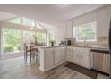 Eat-in kitchen featuring white cabinets, granite countertops, stainless steel appliances, wood floors and a large window at 2071 Arrowhead Trl, Marietta, GA 30062