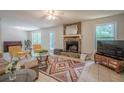 Cozy living room with a stone fireplace, large windows, tile flooring, and stylish furniture at 2071 Arrowhead Trl, Marietta, GA 30062
