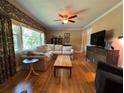 Bright living room with hardwood floors, a comfortable sectional sofa, and natural light from a large window at 224 Sourwood Dr, Marietta, GA 30062