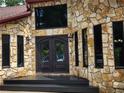 Close-up of the front door showcasing stone detail, transom window, and modern hardware at 4710 Misty Lake Ne Ct, Kennesaw, GA 30144