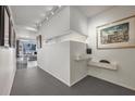 Sleek hallway featuring minimalist decor, track lighting, and a glimpse into a living area at 75 14Th St Ne # 4140, Atlanta, GA 30309