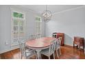 Elegant dining room featuring wood floors, neutral walls and a stylish light fixture at 1211 Riverscall Ln, Atlanta, GA 30339