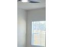 Bright room featuring a window, neutral wall paint, and a ceiling fan with overhead lighting at 246 Crabapple Rd, Mcdonough, GA 30253