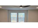 Bright room featuring windows with blind coverings, neutral wall paint, and a ceiling fan with overhead lighting at 246 Crabapple Rd, Mcdonough, GA 30253