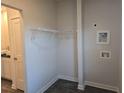 A compact laundry room with wire shelving, utility sink hookups, and modern flooring at 246 Crabapple Rd, Mcdonough, GA 30253
