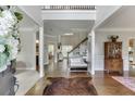 Inviting foyer with hardwood floors, staircase, and elegant decor at 3930 Suwanee Bend Dr, Suwanee, GA 30024