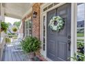 Beautiful front door decorated with a wreath, flanked by plants and featuring a cozy porch at 3930 Suwanee Bend Dr, Suwanee, GA 30024