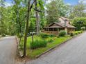Quaint bungalow located on a corner lot with a stone chimney and mature trees at 4624 Park Dr, Pine Lake, GA 30072