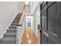 Inviting foyer with hardwood floors, staircase, and open view into the kitchen at 6520 Roswell Rd # 48, Atlanta, GA 30328