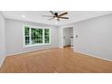 Bright living room with beautiful hardwood floors, ceiling fan, and large windows at 6520 Roswell Rd # 48, Atlanta, GA 30328