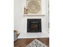 Close-up of fireplace with decorative art, a marble hearth, and a textured stone surround at 1712 Evans Sw Dr, Atlanta, GA 30310