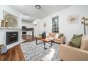 Bright living room with fireplace, hardwood floors, neutral paint, and natural light from a large window at 1712 Evans Sw Dr, Atlanta, GA 30310