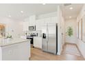 Bright, modern kitchen with white cabinets, granite countertops, and stainless steel appliances at 1876 Copelyn Reese Court (Lot 170), Lawrenceville, GA 30043