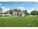 Lovely home showcasing a lush front yard, inviting pathway, and a serene suburban setting at 1915 North Rd, Snellville, GA 30078