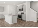 Modern kitchen with stainless steel appliances, granite countertops, island with a sink and wood flooring at 3040 Manor Hill Pl, Union City, GA 30291