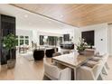 Open-concept living space with hardwood floors, marble accent wall, seamlessly connecting to modern kitchen at 4132 Carmain Ne Dr, Atlanta, GA 30342
