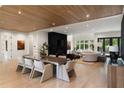 Open concept living and dining area with hardwood floors, recessed lights, and a marble fireplace at 4132 Carmain Ne Dr, Atlanta, GA 30342