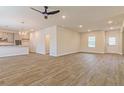 Large living room with wood-look flooring, modern fixtures, and neutral color scheme at 250 Crabapple Rd, Mcdonough, GA 30253