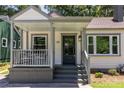 Inviting front porch with seating area and dark front door at 139 Sisson Ne Ave, Atlanta, GA 30317