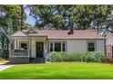Inviting bungalow with a welcoming front porch, lush lawn, and complemented by blooming hydrangeas at 139 Sisson Ne Ave, Atlanta, GA 30317