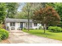 Inviting single-story home with a well-manicured front lawn, driveway, and charming curb appeal at 2572 Beverly Hills Drive Dr, Chamblee, GA 30341