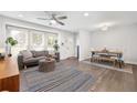 Bright and airy living room with hardwood floors, ceiling fan, comfortable seating, and ample natural light at 2572 Beverly Hills Drive Dr, Chamblee, GA 30341
