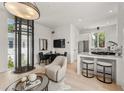 Open-concept living space with modern furniture, natural light, and a unique elevator feature at 380 2Nd St, Fayetteville, GA 30214