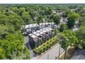 Aerial view of modern townhouses surrounded by lush trees and landscaping in a quiet neighborhood at 710 Oakview Rd, Decatur, GA 30030