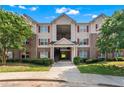 Traditional apartment building featuring brick accents, red shutters, and well-maintained landscaping at 16104 Waldrop Cv, Decatur, GA 30034
