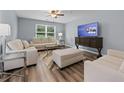 Comfortable living room with contemporary furniture, wood floors, and bright natural light at 16104 Waldrop Cv, Decatur, GA 30034