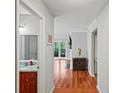 Hallway view showcases hardwood flooring and a glimpse into other rooms, including the bathroom at 212 Brittany Ct, Duluth, GA 30096