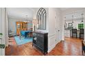 Open-concept dining room with hardwood floors, a large wooden hutch, and a view into the adjacent kitchen at 2346 Unicoi Ct, Duluth, GA 30097