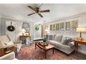 Bright and airy living room with comfortable seating, plantation shutters, and a ceiling fan at 2349 Northlake Ne Ct, Atlanta, GA 30345