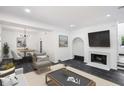 Bright living room features dark floors, modern decor, and a cozy fireplace at 5490 Chemin De Vie, Sandy Springs, GA 30342