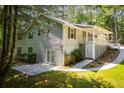 Home featuring a patio, backyard, with mature trees, and a partial covered deck at 6026 Belle Meade Ct, Villa Rica, GA 30180