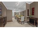 Elegant dining area with mirrored wall and seating for four; view into living room at 1421 Peachtree Ne St # 212, Atlanta, GA 30309