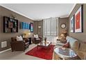 Comfortable living room with plush seating, red rug, and bright natural light from windows at 1421 Peachtree Ne St # 212, Atlanta, GA 30309