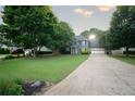 Charming two-story home with manicured lawn and long driveway on a tree-lined lot at 4130 Providnce Square, Alpharetta, GA 30009