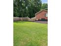 Large backyard with a newly installed wooden fence and mature trees at 6210 Douglas Manor Ct, Douglasville, GA 30134