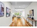 Hallway view leading to a dining room and living room with bright lighting and modern artwork at 862 Hobson Street Southwest Sw St, Atlanta, GA 30310