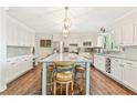 Bright, open kitchen with white cabinets, large center island with seating, and stainless steel appliances at 980 Casteel Rd, Powder Springs, GA 30127