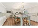Stylish kitchen featuring a large island with bar stools, stainless appliances, and white cabinetry at 980 Casteel Rd, Powder Springs, GA 30127