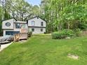 View of the home's lush green front yard and the home's charming exterior at 2816 Quinbery Dr, Snellville, GA 30039