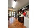 View of a long kitchen featuring granite countertops, stainless steel appliances, and wood-look flooring at 2816 Quinbery Dr, Snellville, GA 30039
