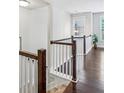 Bright hallway with hardwood floors, white wainscoting, and a stylish pendant light at 2817 White Oak Ln, Decatur, GA 30032