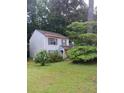 Light blue two-story home with green lawn and mature trees in the yard at 2939 Carrie Farm Nw Rd, Kennesaw, GA 30144