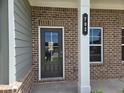 Close up of the front door of a brick home with the house number at 702 Bristol Dr, Loganville, GA 30052