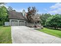 Inviting exterior view featuring a well-maintained lawn and a two-car garage at 1235 Waterwood Dr, Loganville, GA 30052